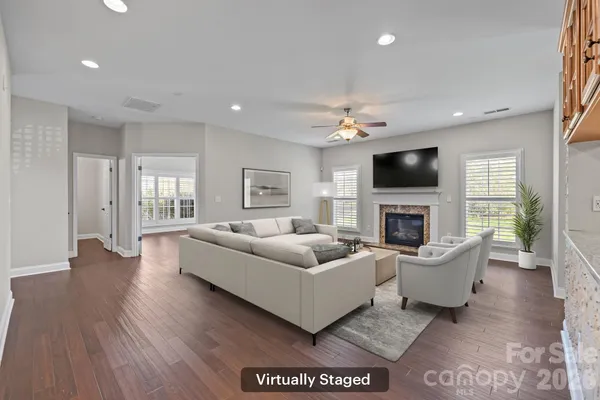 a living room with furniture a fireplace and a flat screen tv