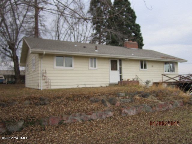 a front view of house with yard and trees