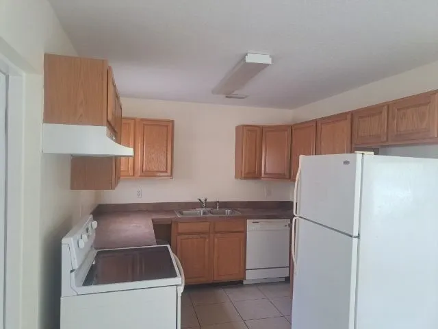 a white refrigerator freezer sitting in a kitchen