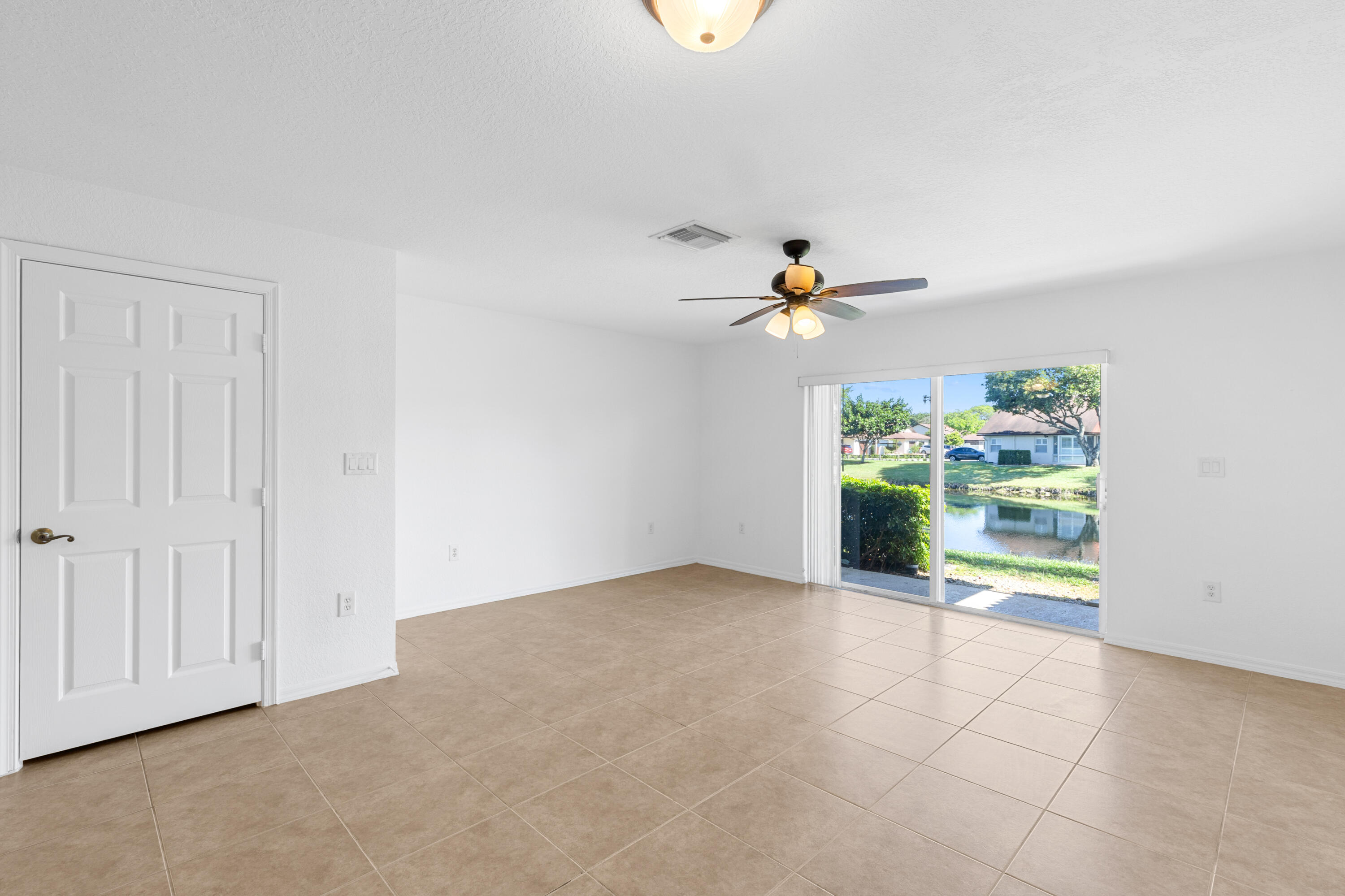 9107 Chambers Street, Unit 9107 Tamarac, FL 33321 - Photo 9 of 30 a view of a livingroom with a ceiling fan and window