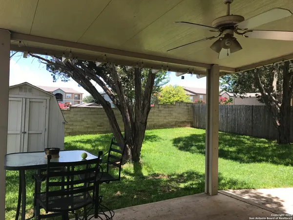 a view of backyard with plants and outdoor seating