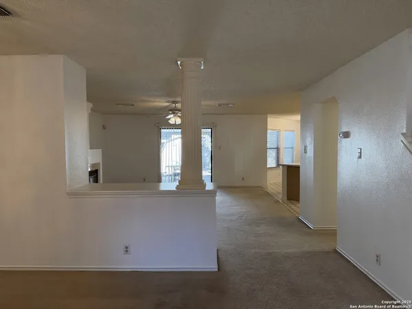 a view of empty room with a fireplace