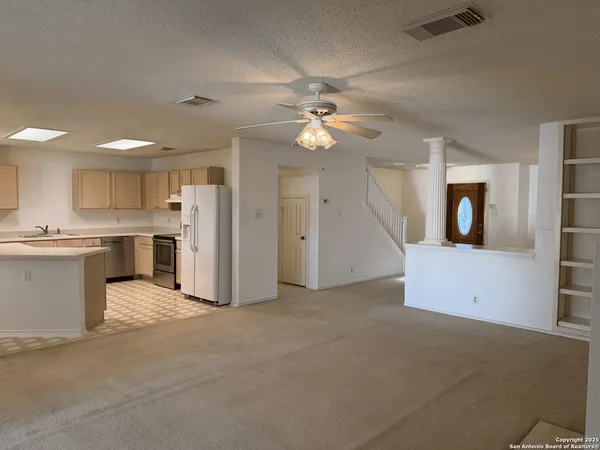 a large kitchen with kitchen island stainless steel appliances a counter space a sink and cabinets
