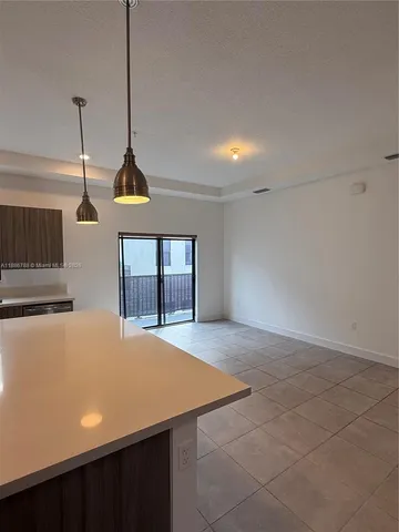 a view of an empty room with windows