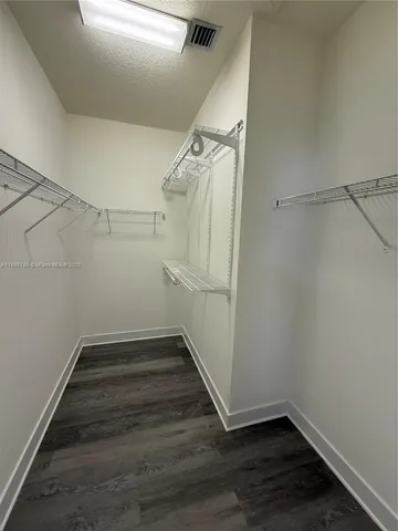a view of a room with wooden floor and white walls