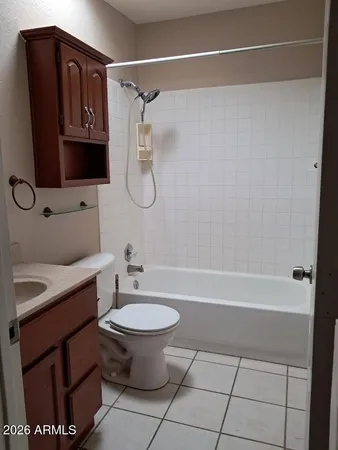 a bathroom with a granite countertop sink a toilet and bathtub