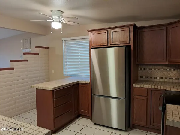a kitchen with stainless steel appliances granite countertop a refrigerator a stove a sink and dishwasher