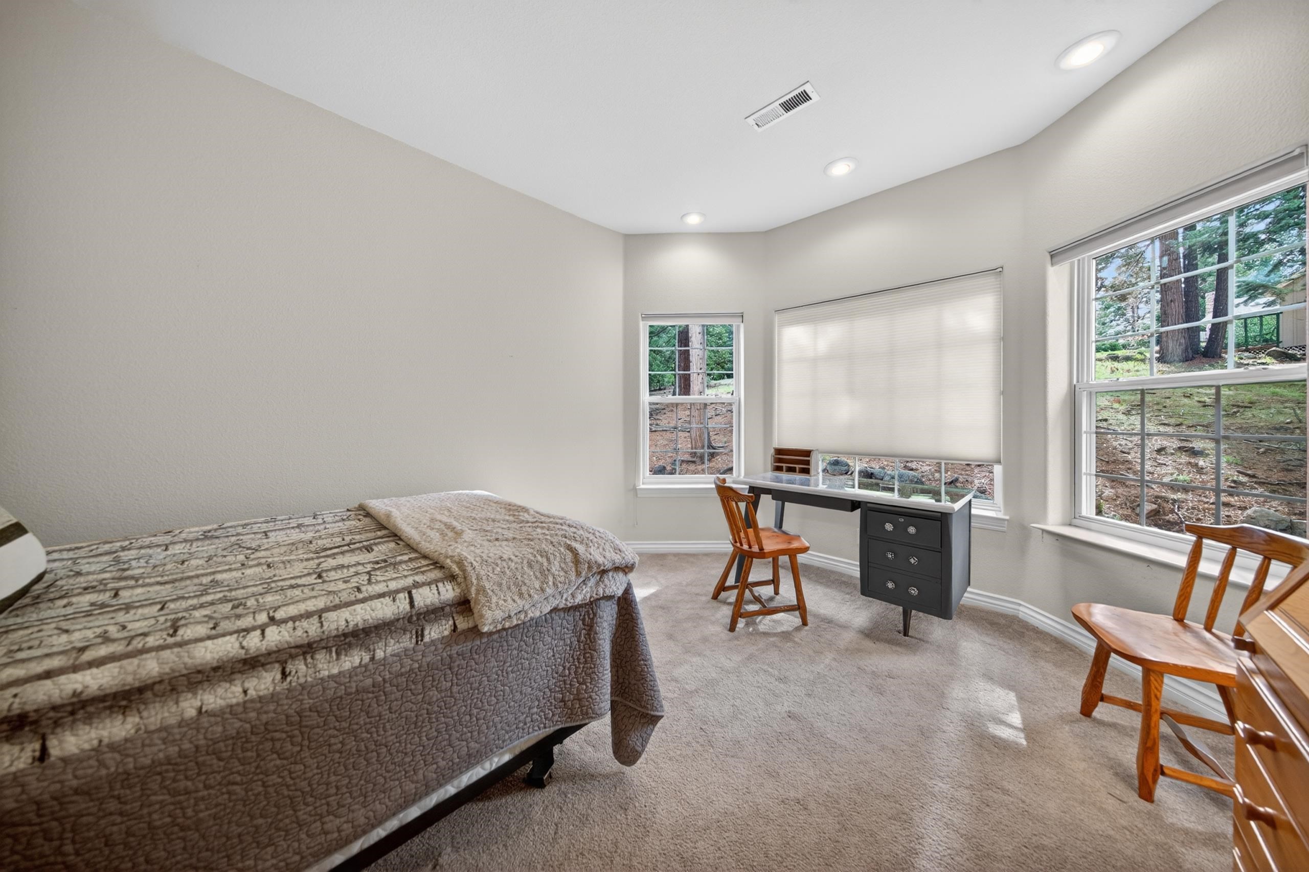 1017 Timber Ridge Road Lake Almanor, CA 96137 - Photo 27 of 45 a bed sitting in a spacious bedroom next to a window