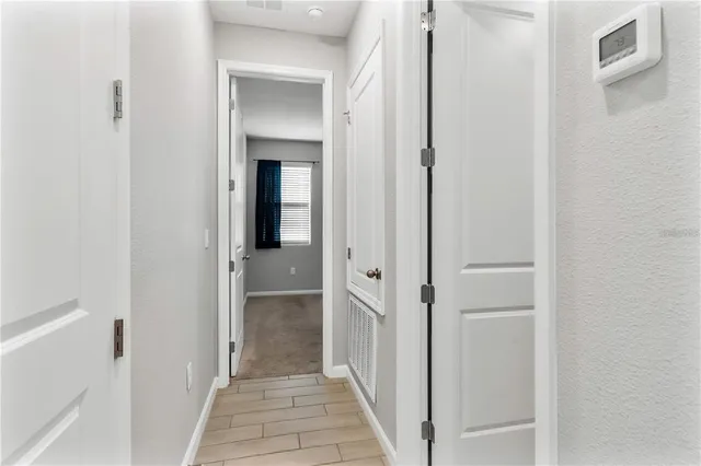 an empty room with windows and entrance