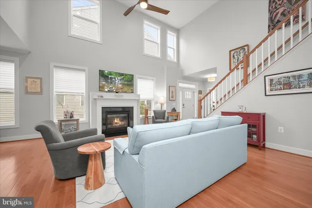 a living room with furniture a fireplace and a window