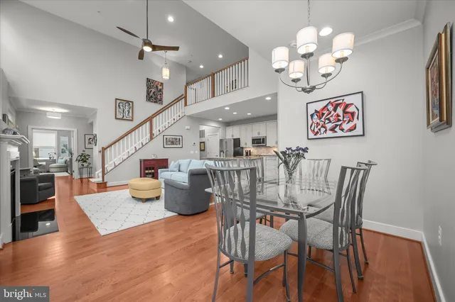 a view of a dining room with furniture a chandelier and wooden floor