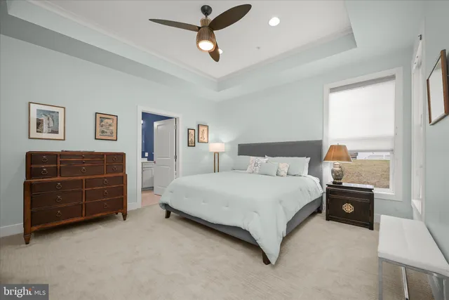 a large bedroom with a large bed and a chandelier