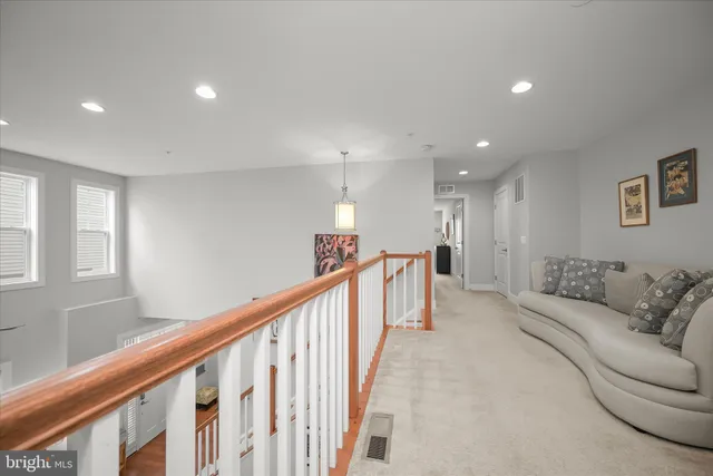 a bedroom with a bed a couch and a window