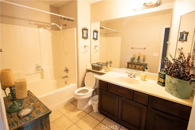 a bathroom with a double vanity sink toilet mirror and bathtub
