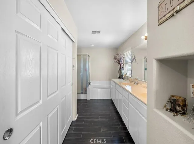 a bathroom with a sink a mirror and a shower