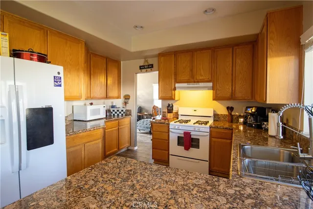 a kitchen with a refrigerator stove and sink
