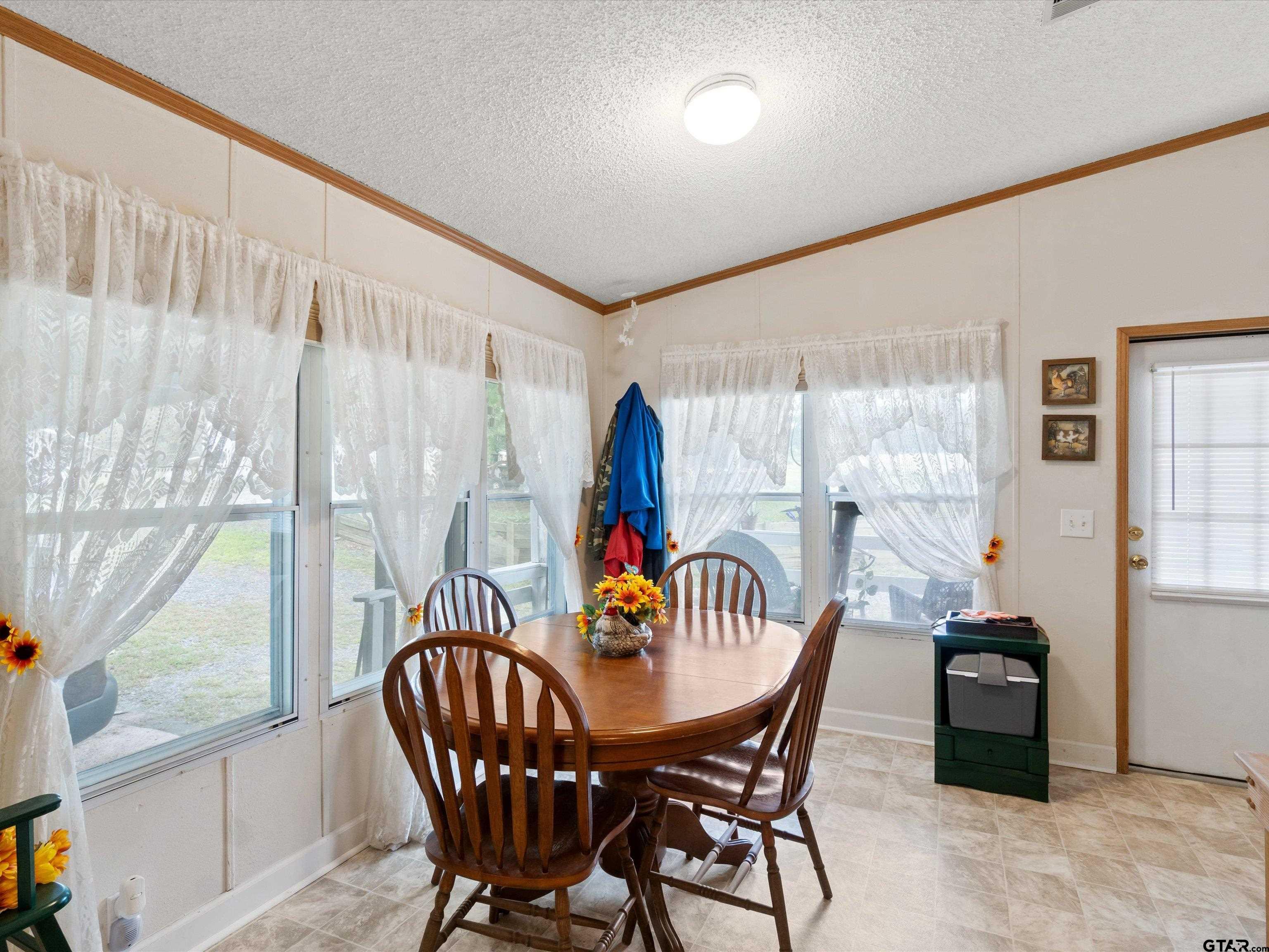 2811 Medlin Road Gilmer, TX 75645 - Photo 20 of 30 a dining room with furniture window and outside view