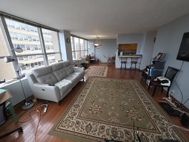 a kitchen with granite countertop stainless steel appliances a stove sink and cabinets