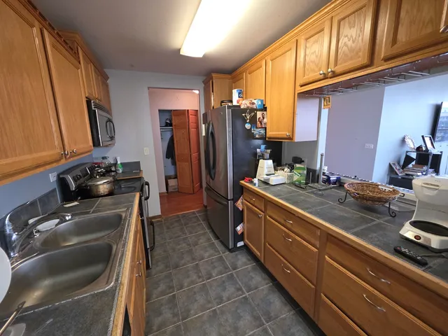 a bedroom with a bed chair and window