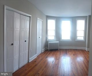 2025 South 3rd Street, Unit 2 Philadelphia, PA 19148 - Photo 2 of 8 a view of an empty room with wooden floor and a window