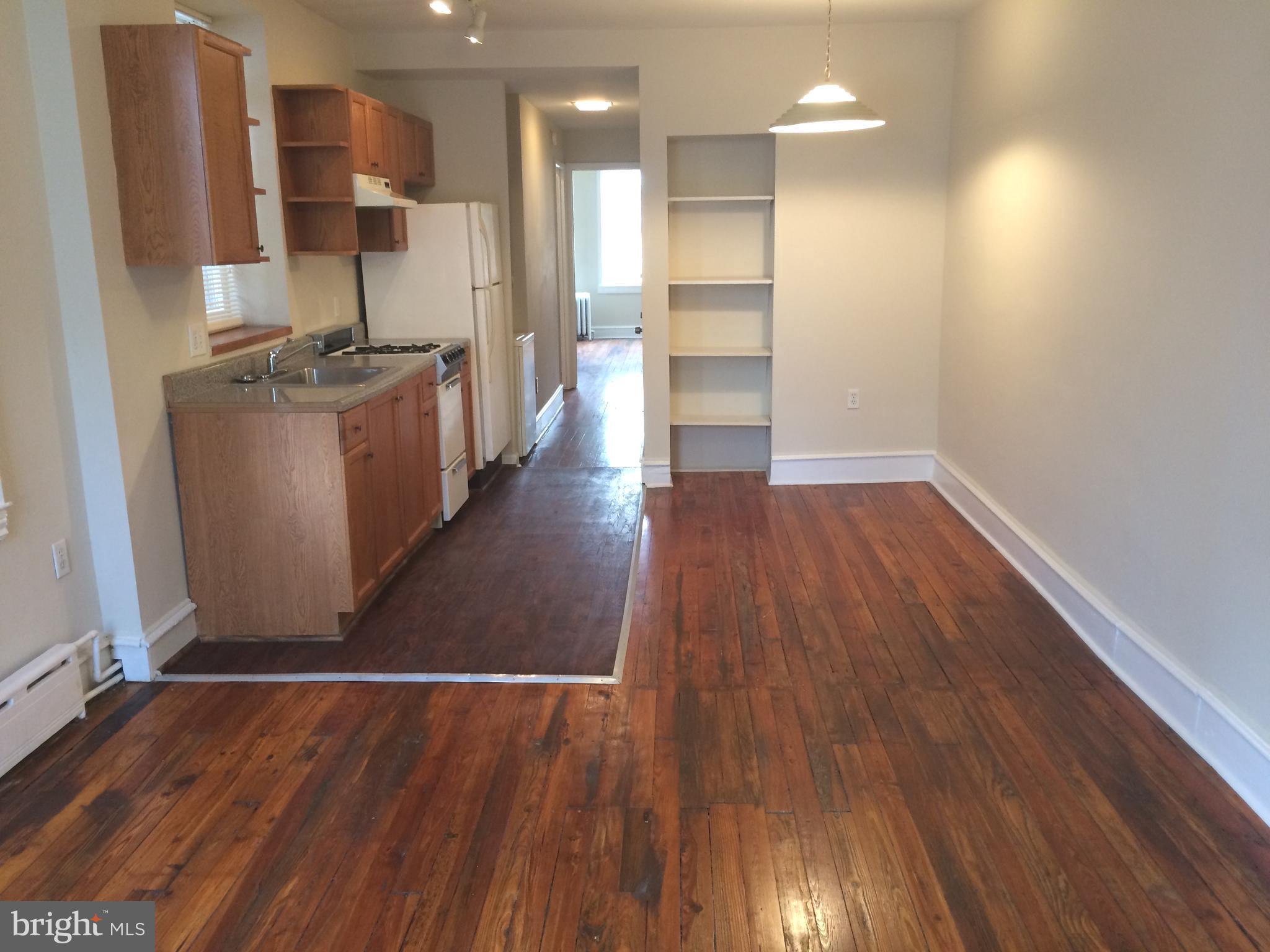 2025 South 3rd Street, Unit 2 Philadelphia, PA 19148 - Photo 7 of 8 a view of a kitchen with wooden floor and a sink