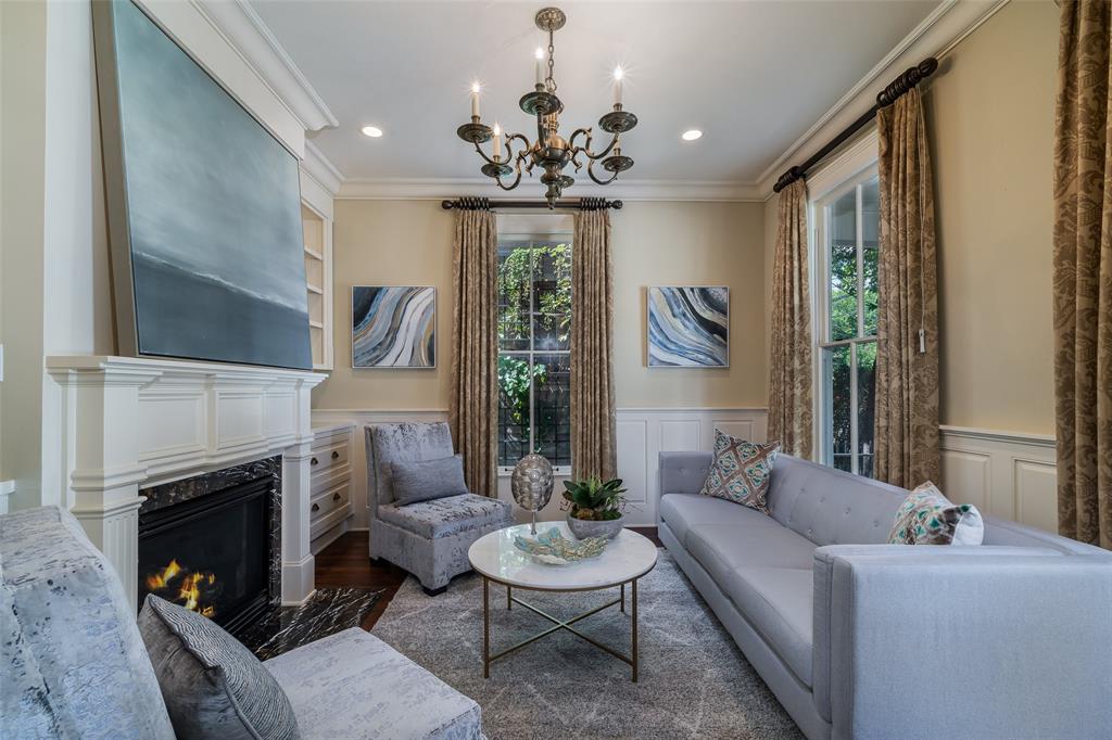 2315 Routh Street Dallas, TX 75201 - Photo 8 of 38 a living room with furniture a chandelier and a fireplace