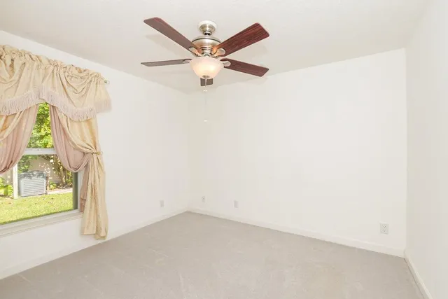 a view of kitchen with stainless steel appliances a refrigerator and cabinets