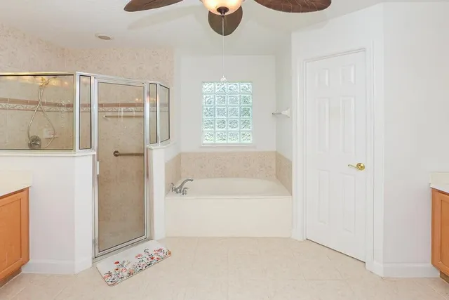 a spacious bathroom with a granite countertop sink and a mirror