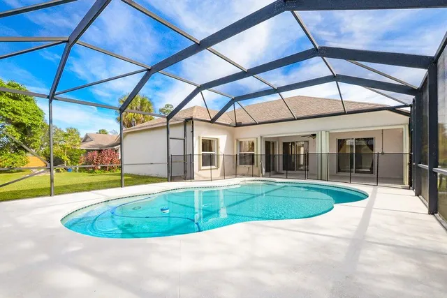 a view of a white building with a swimming pool