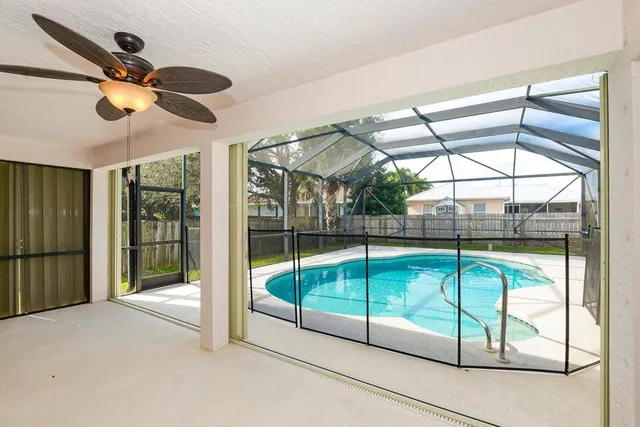 a view of a livingroom with a ceiling fan and window