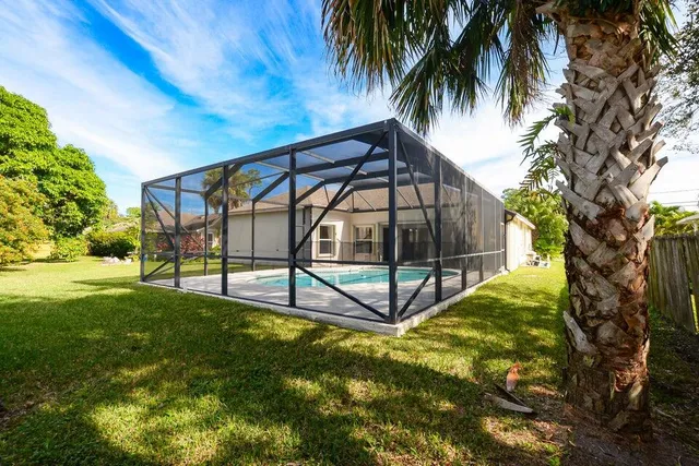 a view of a backyard with a garden and entertaining space