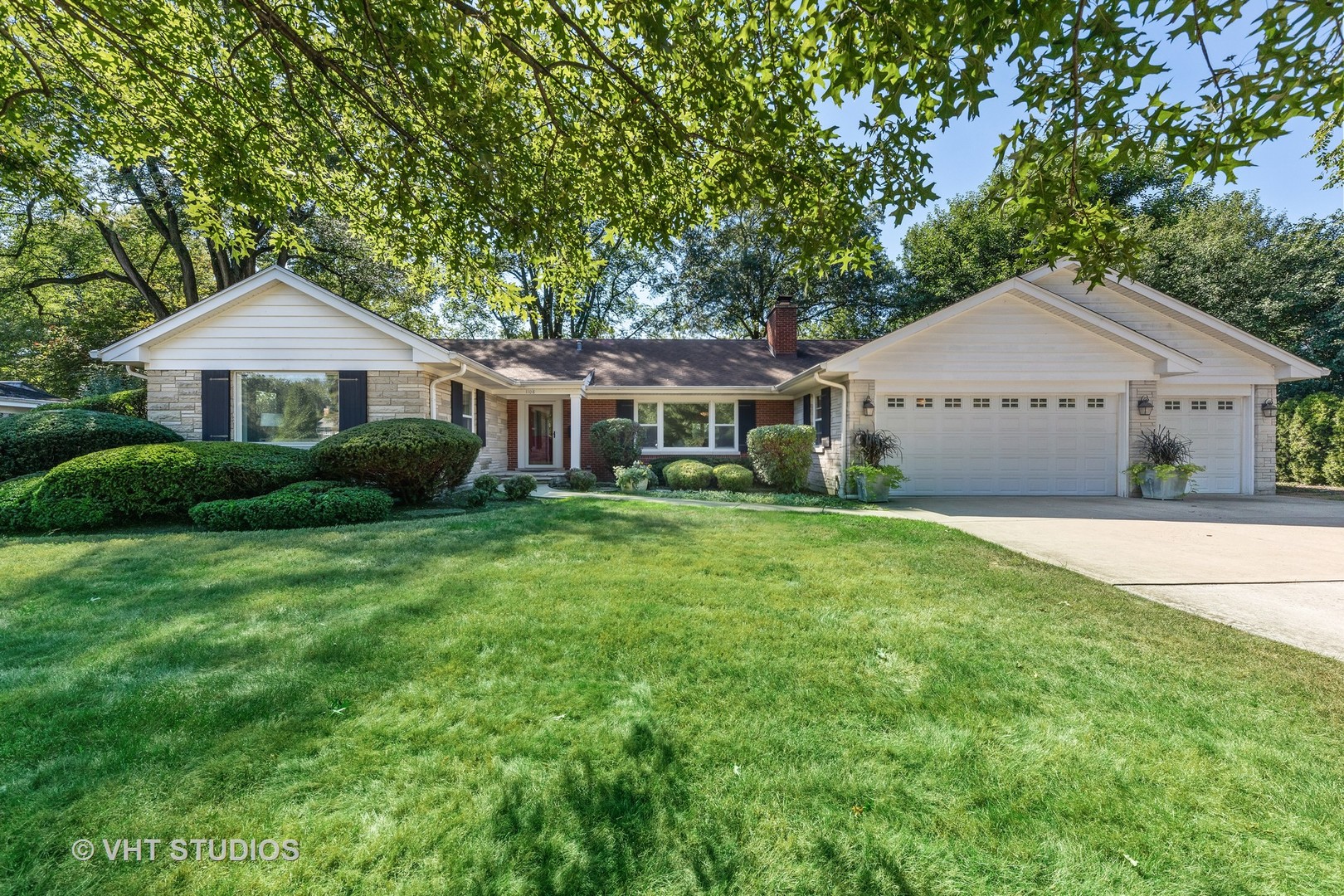 1108 Woodview Road Burr Ridge, IL 60527 - Photo 1 of 29 a front view of a house with a garden