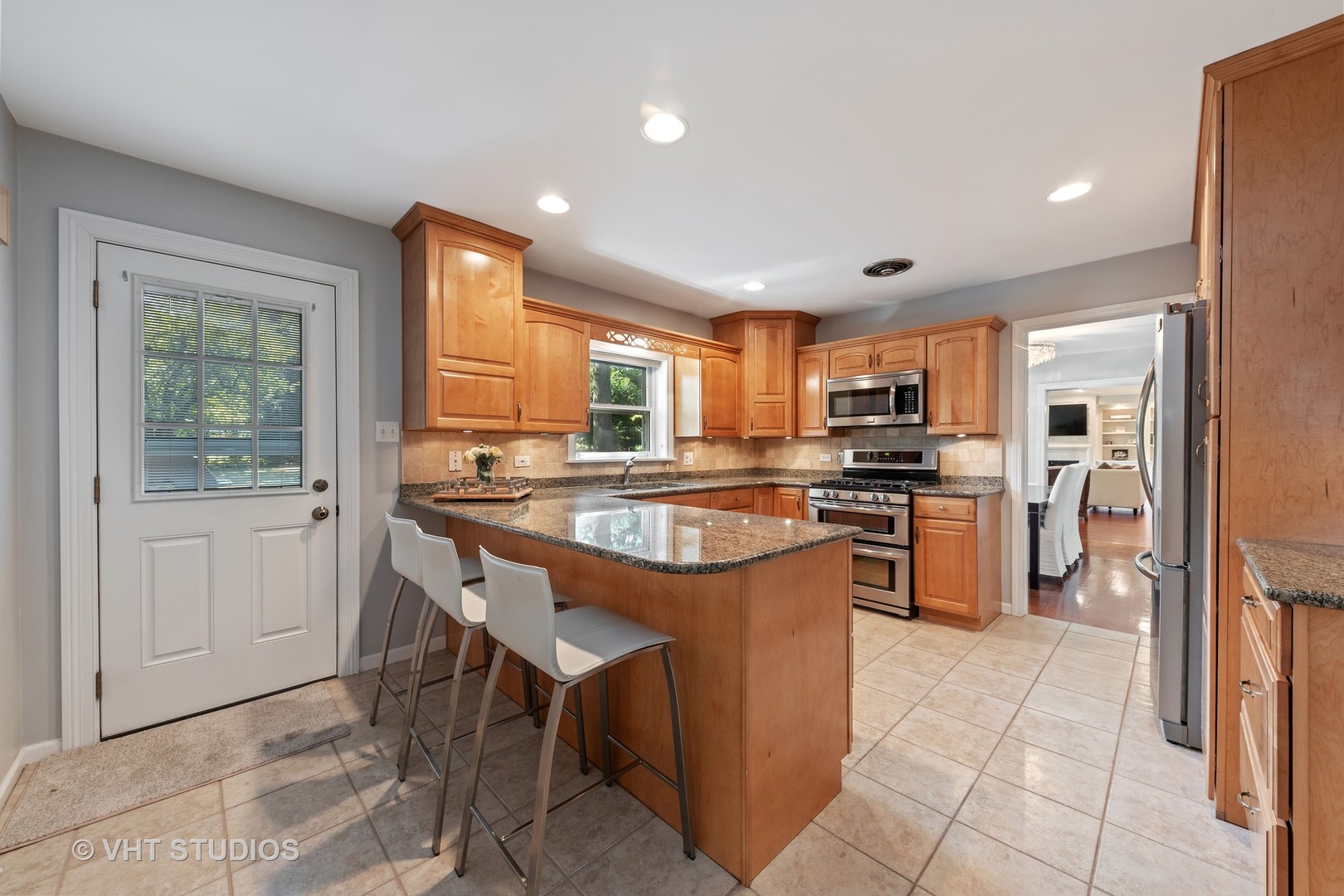1108 Woodview Road Burr Ridge, IL 60527 - Photo 12 of 29 a kitchen with stainless steel appliances granite countertop a stove top oven a sink dishwasher and a refrigerator