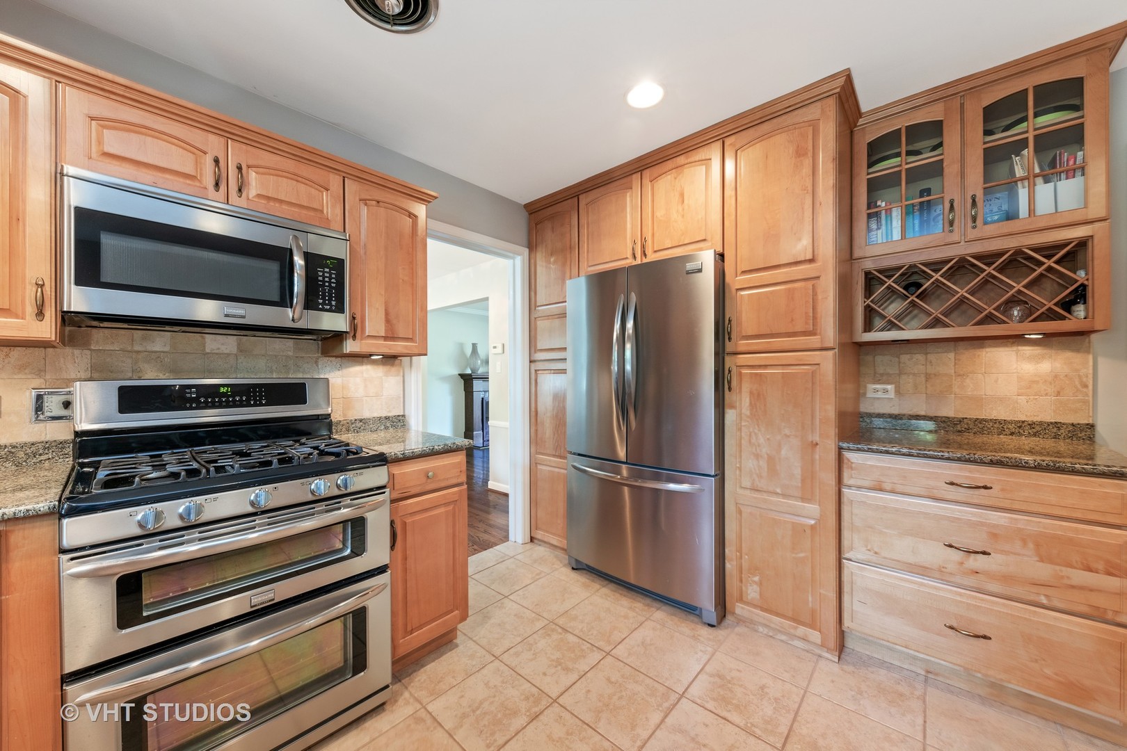 1108 Woodview Road Burr Ridge, IL 60527 - Photo 13 of 29 a kitchen with stainless steel appliances granite countertop a refrigerator and a stove top oven
