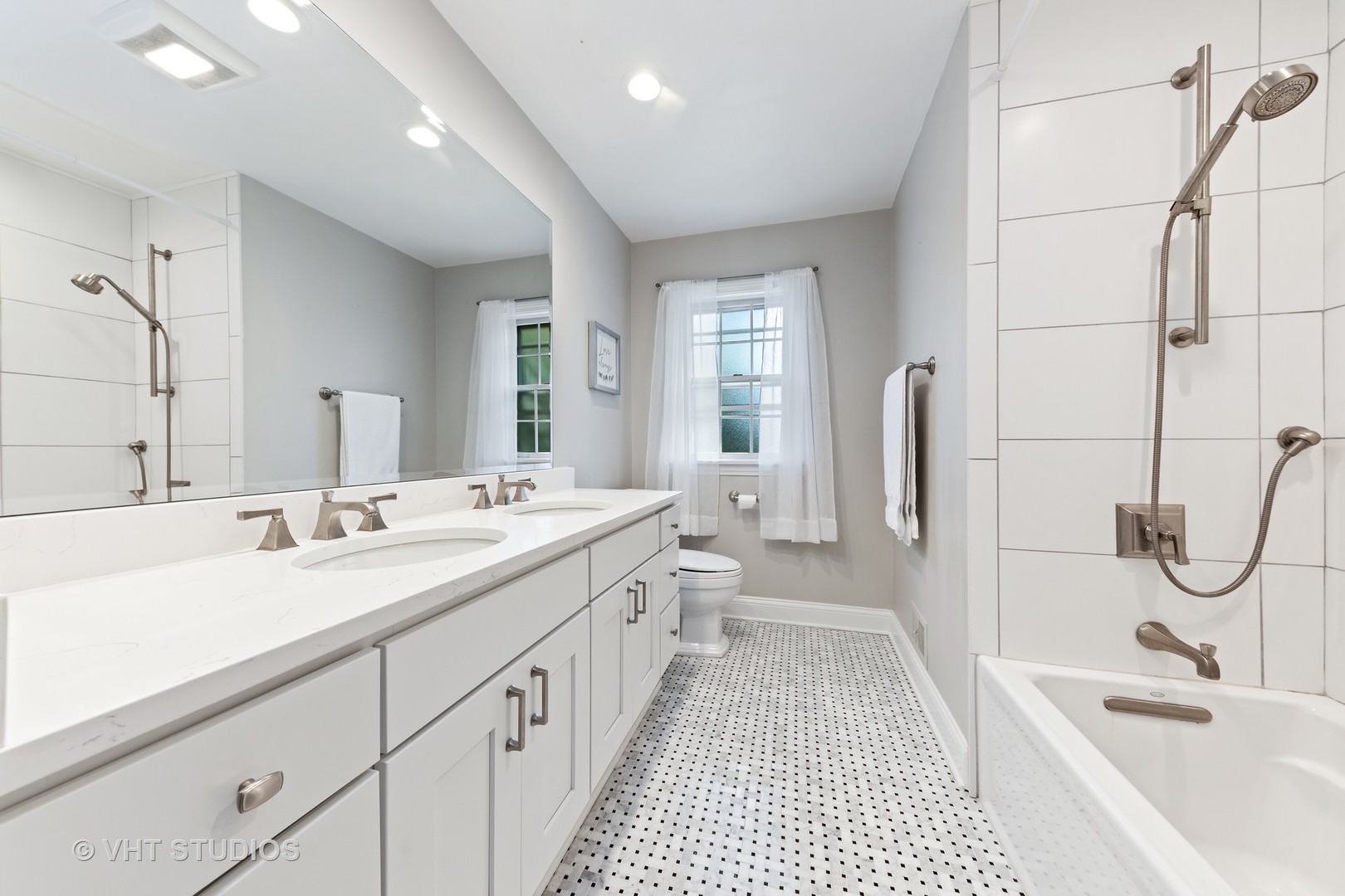 1108 Woodview Road Burr Ridge, IL 60527 - Photo 15 of 29 a bathroom with a double vanity sink large mirror and a bathtub