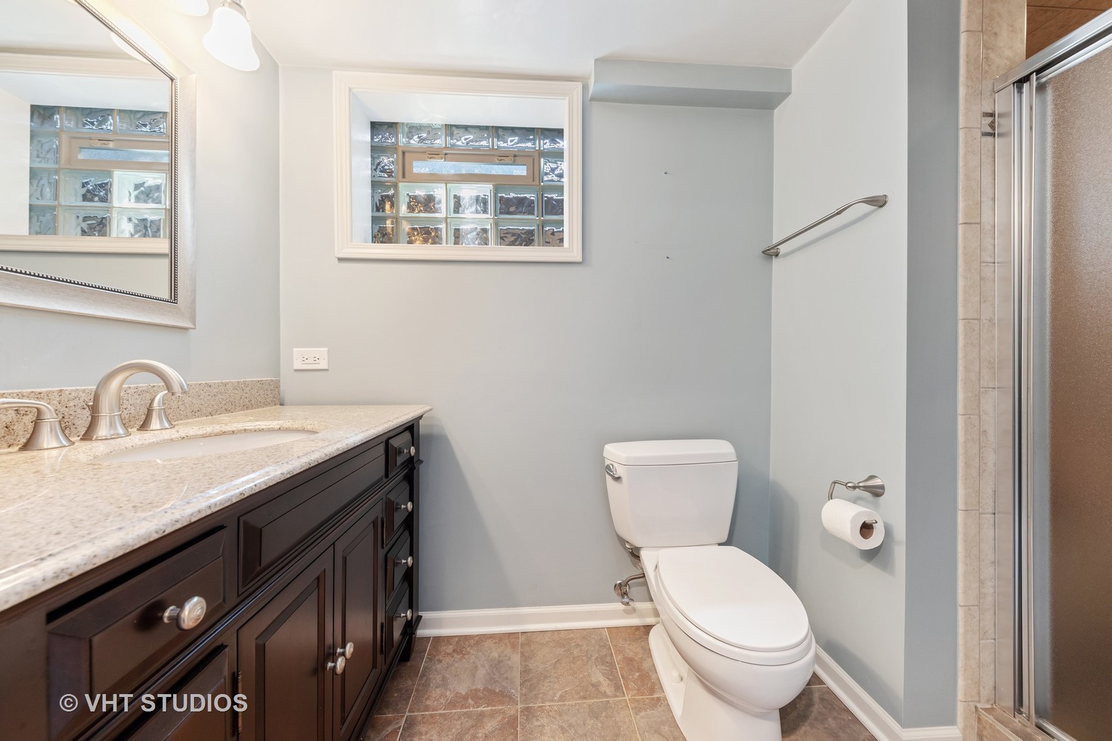 1108 Woodview Road Burr Ridge, IL 60527 - Photo 22 of 29 a bathroom with a granite countertop toilet sink and mirror