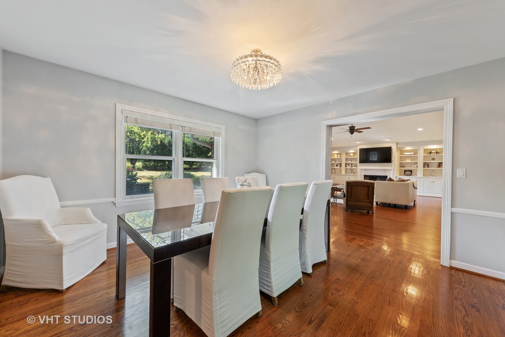1108 Woodview Road Burr Ridge, IL 60527 - Photo 5 of 29 a living room with furniture a dining table and a fireplace