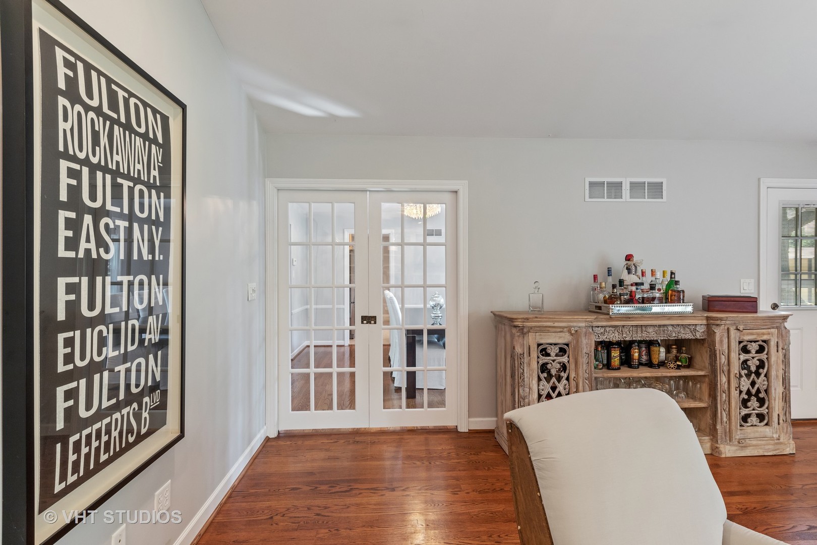 1108 Woodview Road Burr Ridge, IL 60527 - Photo 7 of 29 a living room with a couch and a dining table with wooden floor