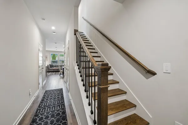 a view of entryway and hall with wooden floor