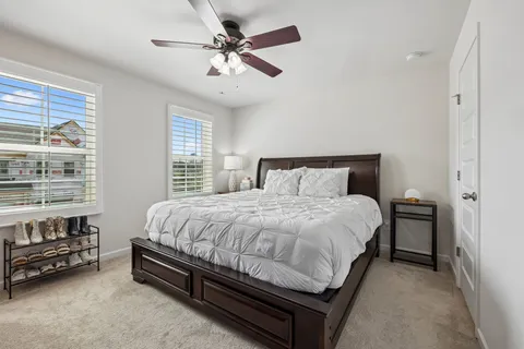 a bed sitting in a bedroom next to a window