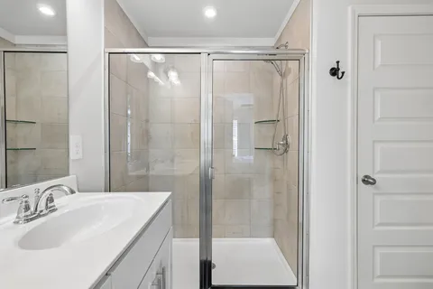 a bathroom with a shower sink and mirror