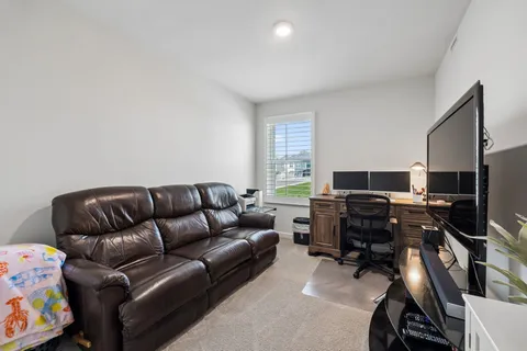 a livingroom with workspace and a window