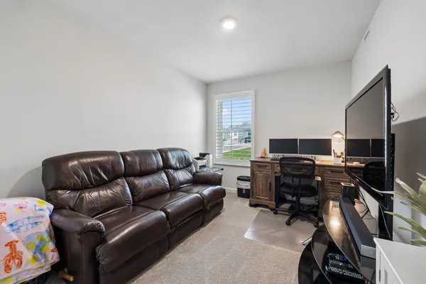 a livingroom with workspace and a window