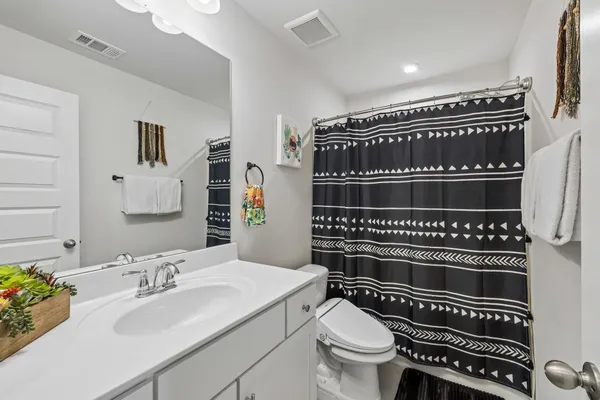a bathroom with a toilet a sink and a mirror