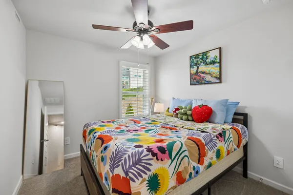 a bedroom with a bed and a chandelier
