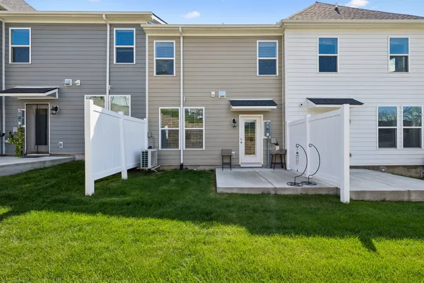a front view of a house with a garden and plants