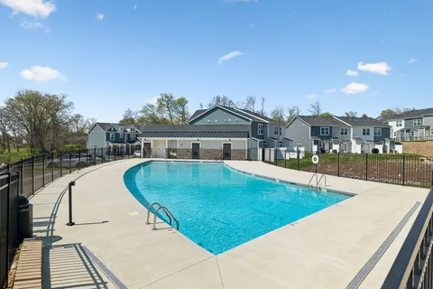 a swimming pool with outdoor seating and yard