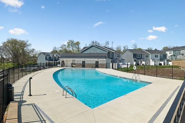 a swimming pool with outdoor seating and yard