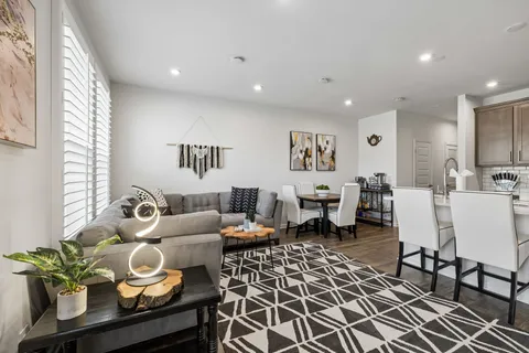 a living room with furniture and wooden floor