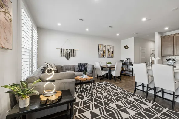 a living room with furniture and wooden floor